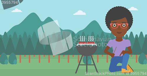 Image of Woman preparing barbecue.