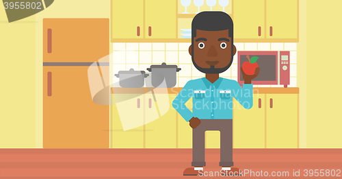 Image of Man holding apple.