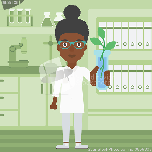 Image of Laboratory assistant with test tube.