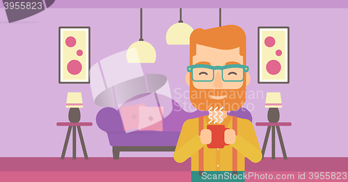 Image of Man holding cup of coffee.