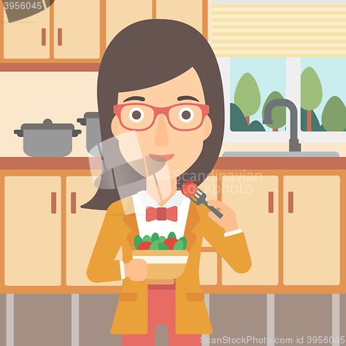 Image of Woman eating salad.