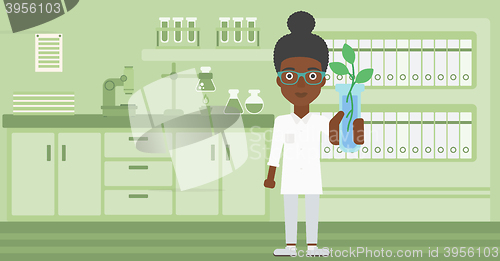 Image of Laboratory assistant with test tube.