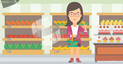 Image of Woman holding supermarket basket.