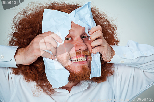 Image of Angry man tear out paper