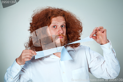 Image of Angry man tear out paper