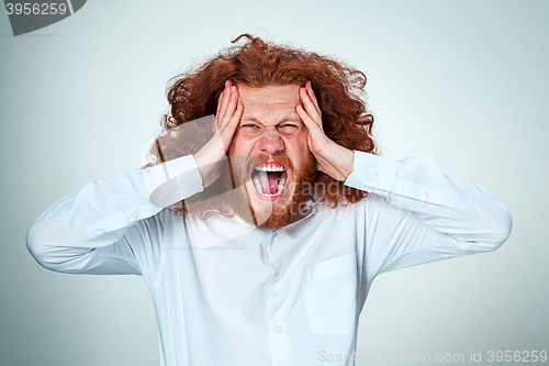 Image of Stressed businessman with a headache