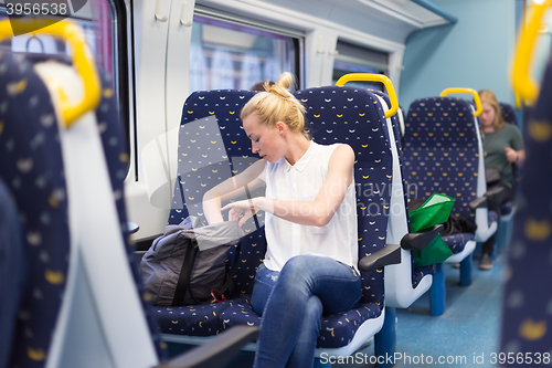 Image of Woman travelling by train.