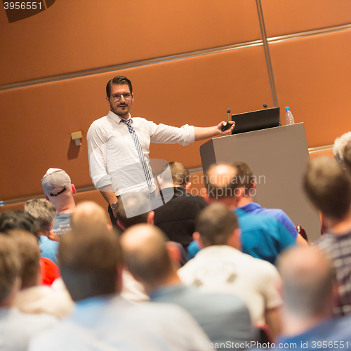 Image of Business speaker giving a talk in conference hall.