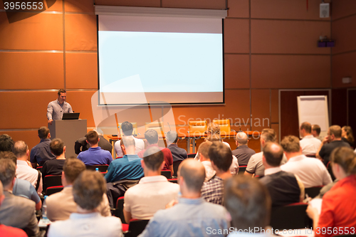 Image of Business speaker giving a talk in conference hall.