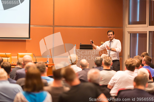 Image of Business speaker giving a talk in conference hall.