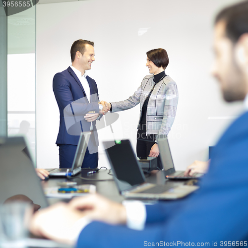 Image of Business people shaking hands.