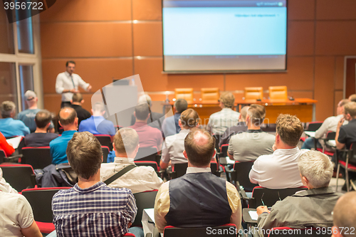 Image of Business speaker giving a talk in conference hall.