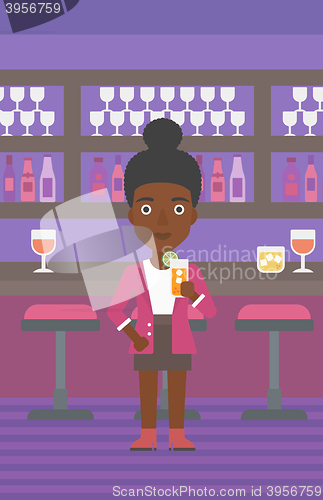 Image of Woman holding glass of juice.