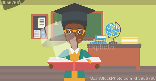 Image of Woman in graduation cap holding book.