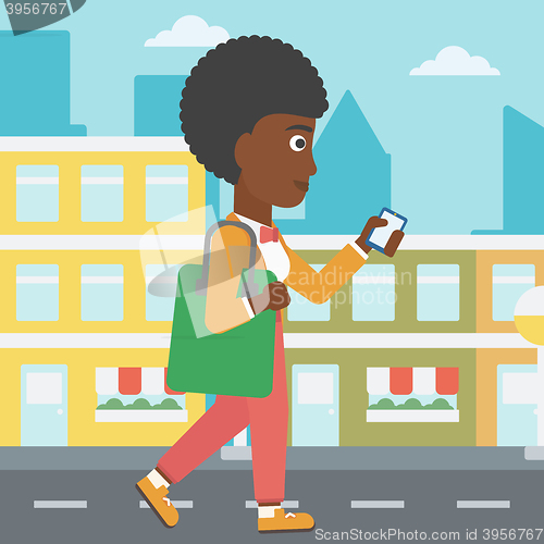 Image of Woman walking with smartphone.