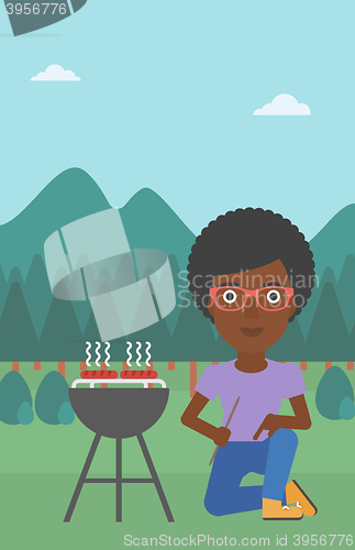 Image of Woman preparing barbecue.