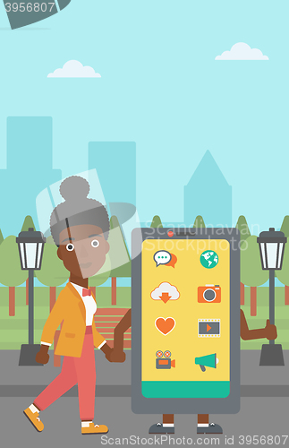 Image of Woman walking with smartphone.