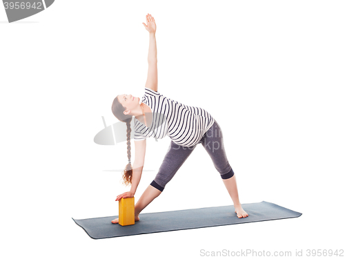 Image of Pregnant woman doing yoga asana Utthita trikonasana