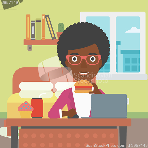 Image of Woman eating hamburger. 