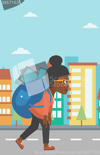 Image of Woman with backpack full of devices.