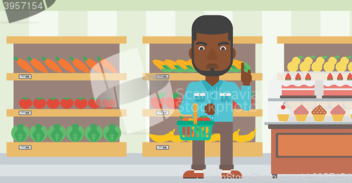 Image of Man holding supermarket basket.