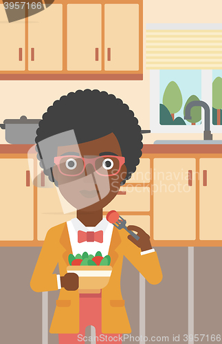 Image of Woman eating salad.