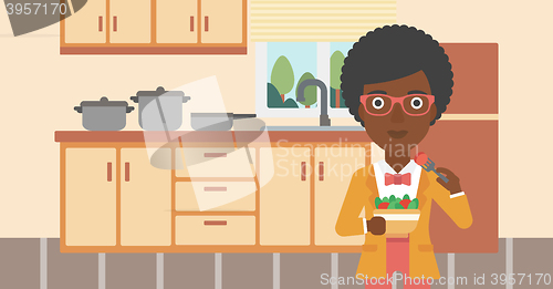 Image of Woman eating salad.