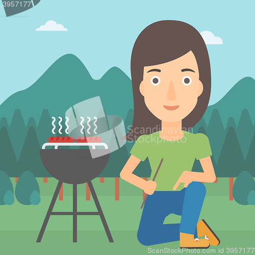 Image of Woman preparing barbecue.