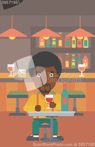 Image of Man sitting at bar.