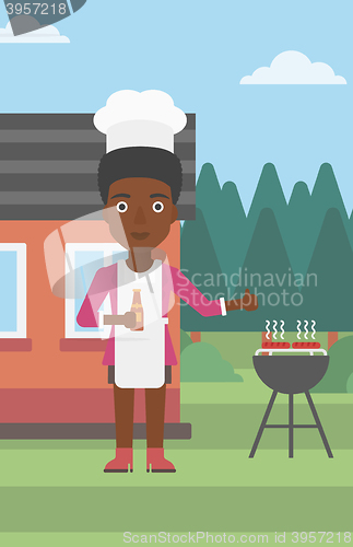 Image of Woman preparing barbecue.