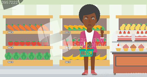 Image of Woman holding supermarket basket.