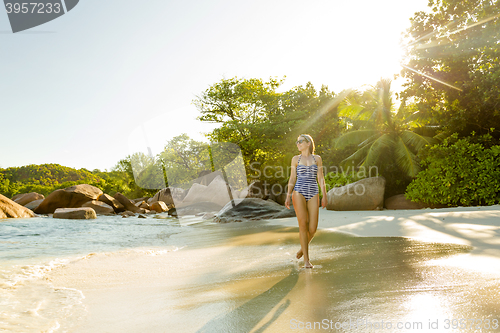 Image of A beautiful woman walking on the beach