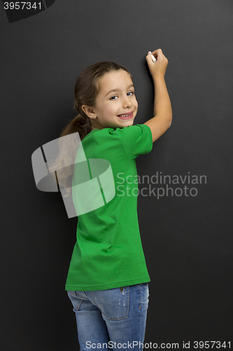 Image of Girl writing in a blackboard