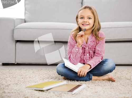 Image of Little girl making homework