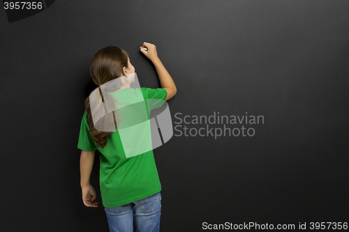 Image of Girl writing in a blackboard