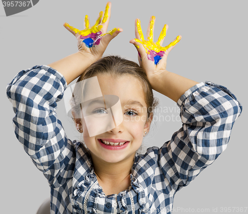 Image of Little girl with hands in paint