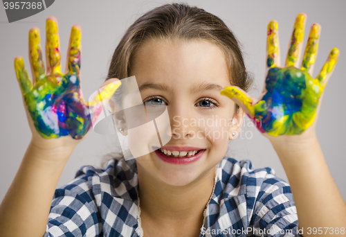 Image of Little girl with hands in paint