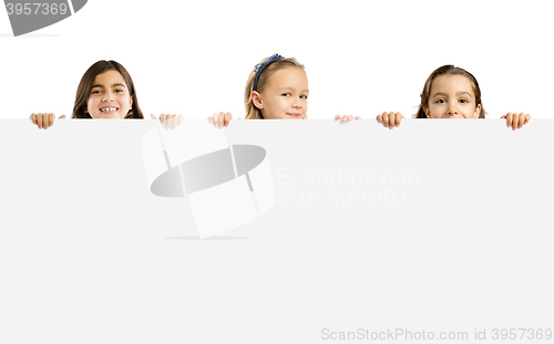 Image of Little girls holding a white board