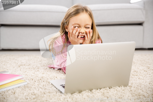 Image of Little girl working with a laptop