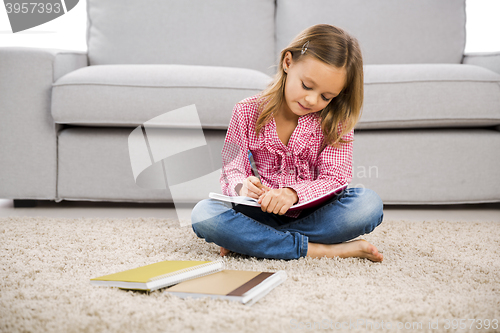 Image of Little girl making homework