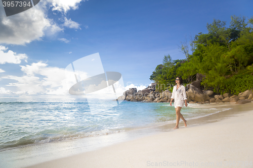 Image of A beautiful woman walking on the beach