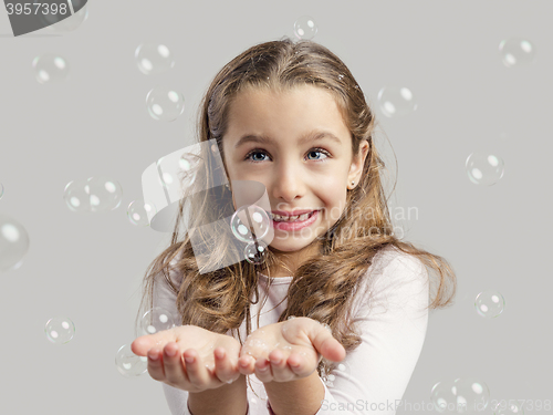 Image of Girl playing with soap bubbles