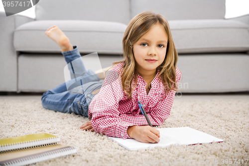 Image of Little girl making homework
