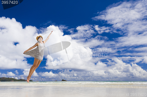 Image of Beautiful woman jumping at the beach