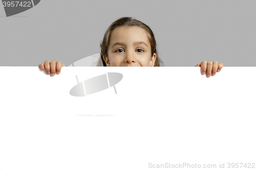 Image of Cute girl holding a blankboard