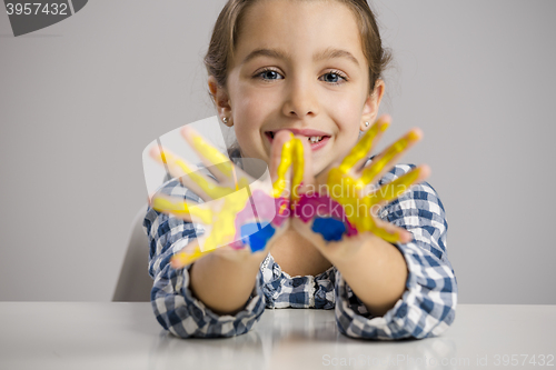 Image of Little girl with hands in paint