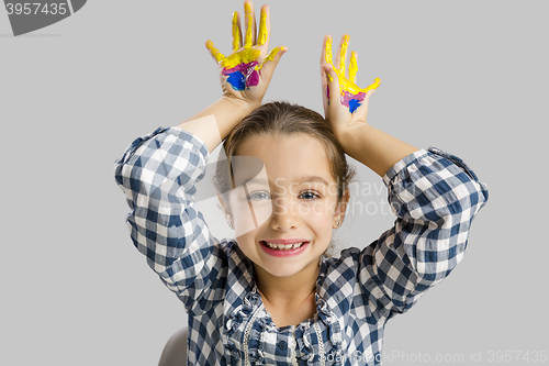 Image of Little girl with hands in paint