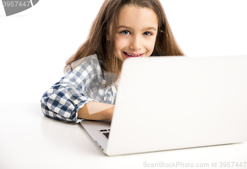 Image of Little girl working with a laptop