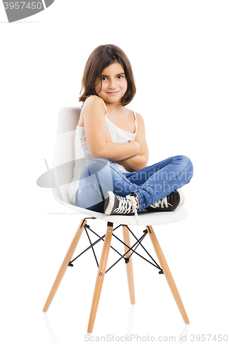 Image of Beautiful young girl sitting on a chair