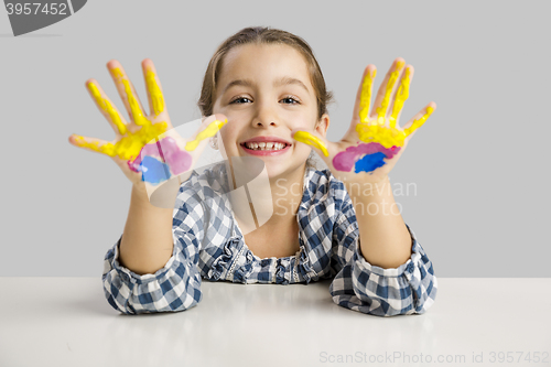 Image of Little girl with hands in paint